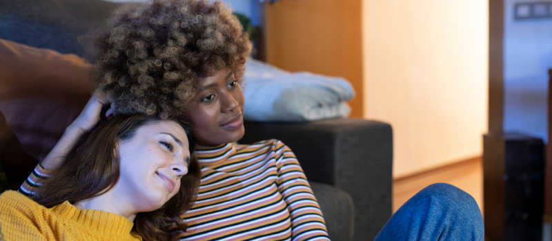 A young woman sits with her partner who is her support system.