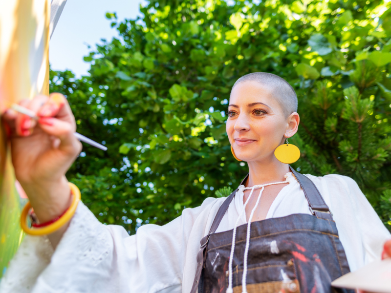 A young woman does art therapy to help cope with depression.