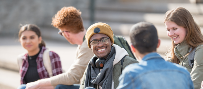 A young man who has OCD is enjoying time outside with his friends.