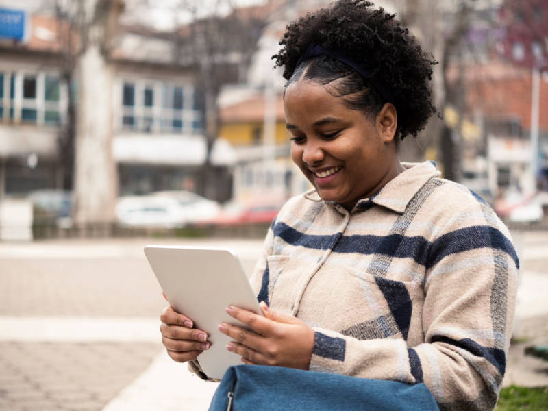 A young woman with OCD is reading about what she needs to know about neurodivergence and OCD.