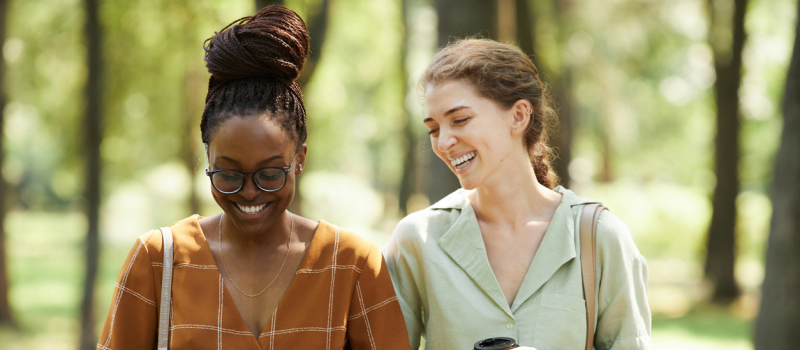 A woman walks with her friend who has recently been healing from a breakup.