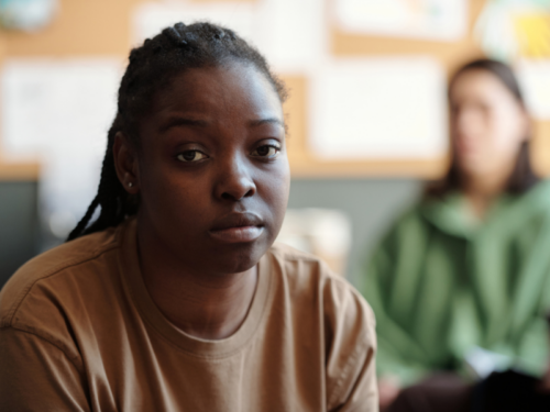 A young woman experiencing warning signs of suicidal ideation.