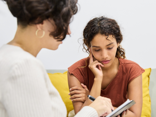 A woman sits in therapy that is covered by Medicaid.