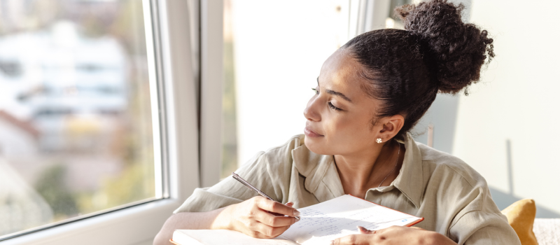 A woman fills out a DBT diary card.