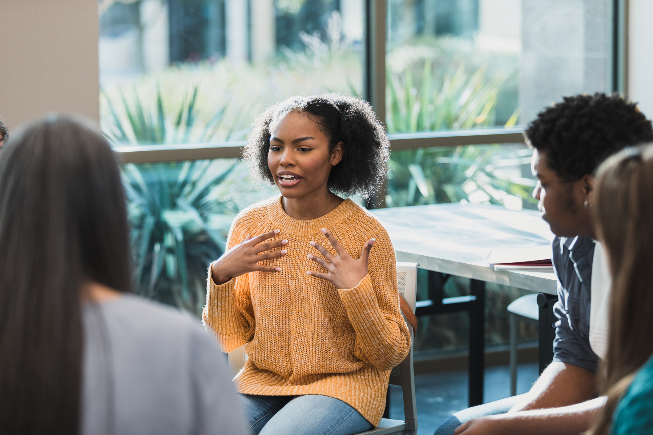 During a group therapy session for teenagers, a teenage girl discusses her social anxiety.