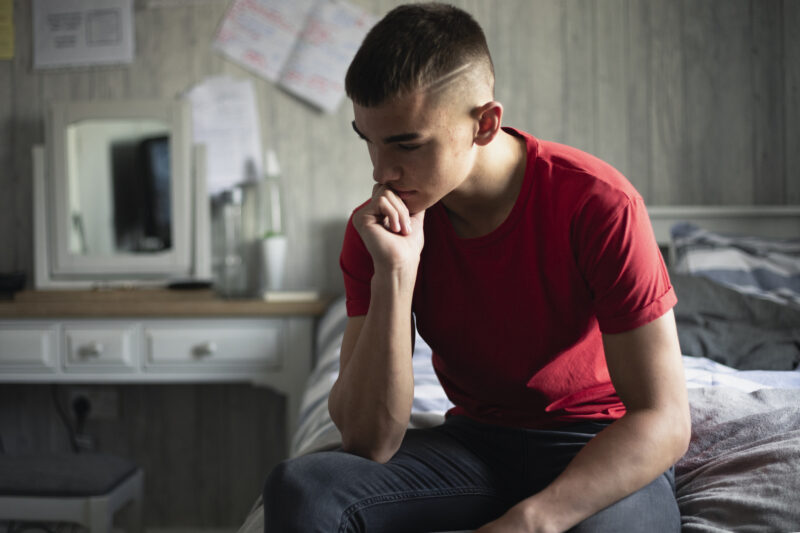 Emotional teenage boy stressed about marijuana use.