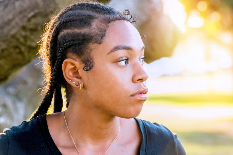 Young woman looking away thinking about her complex PTSD and its impact on her memory