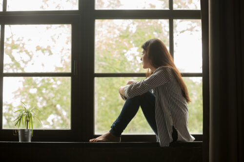 Young woman pensive and caught up in the ways she acts to people please and more.