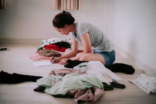 Woman organizing her closet in an obsessive way.