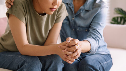 Young woman trying to get support from her loved one as she has a hard moment, processing her grief.