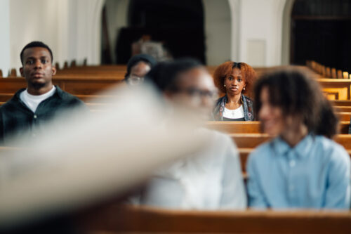 Woman sitting in church feeling overwhelmed and lost