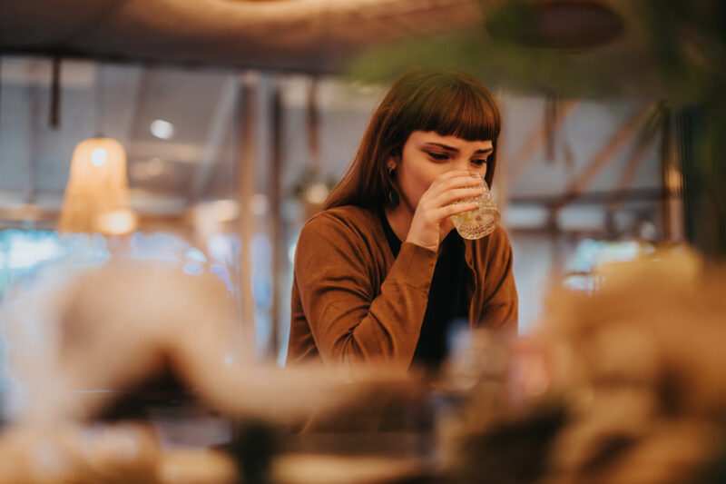 Young woman battling her anxiety using alcohol